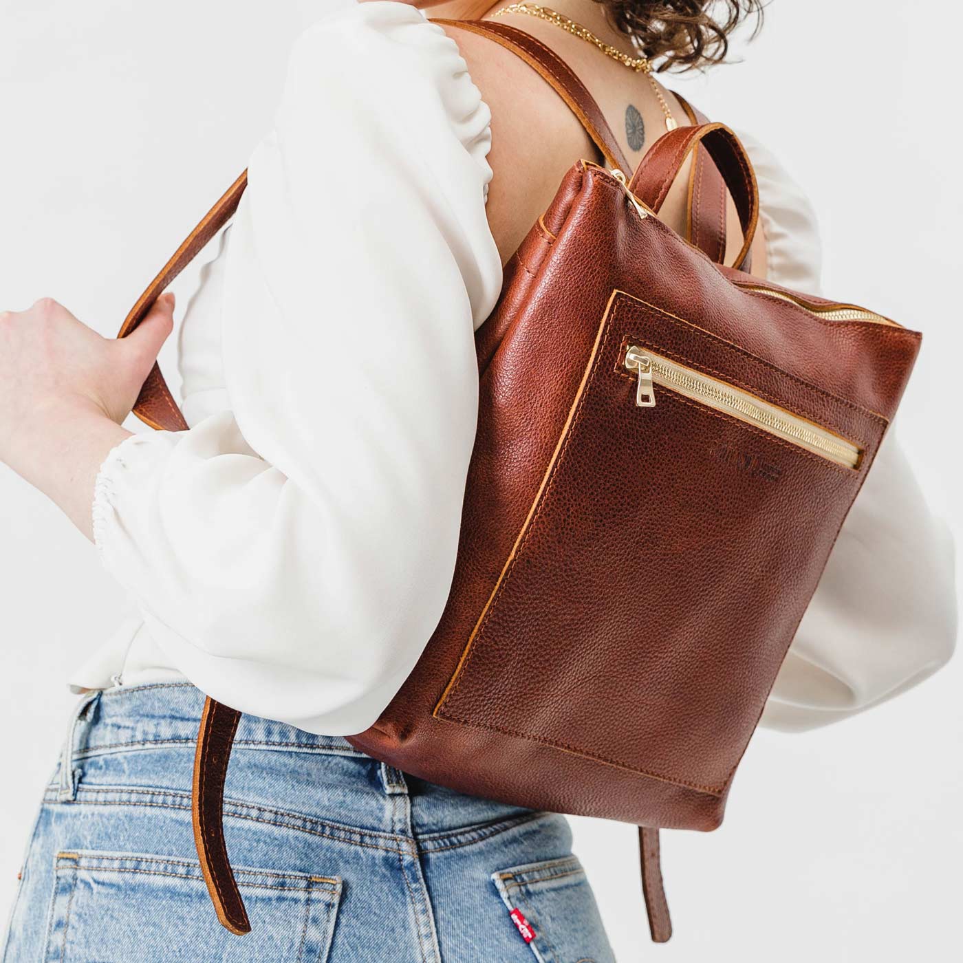 All Color: Nutmeg | Model wearing square slim leather tote backpack